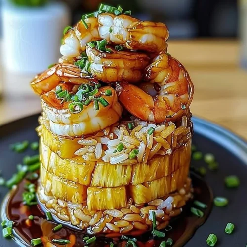 Teriyaki shrimp served with pineapple rice stack on a plate.