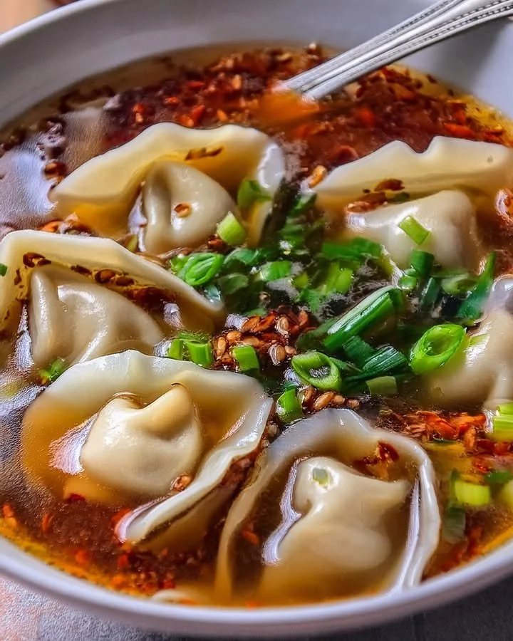 Bowl of homemade weeknight wonton soup with fresh ingredients.